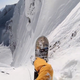 Illustration for article titled Insane guy rappels down a vertical rock wall to snowboard at hyperspeed
